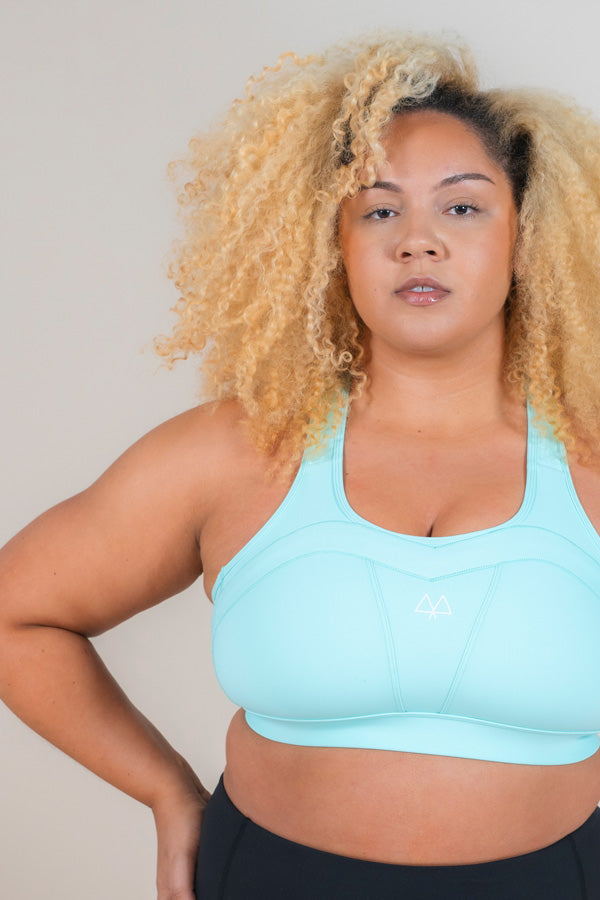 Strong woman wearing MAAREE Empower Sports Bra in Spearmint Green colour